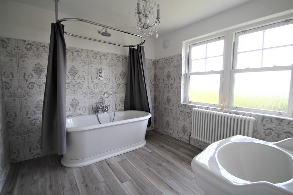tiled bathroom with a bath tub