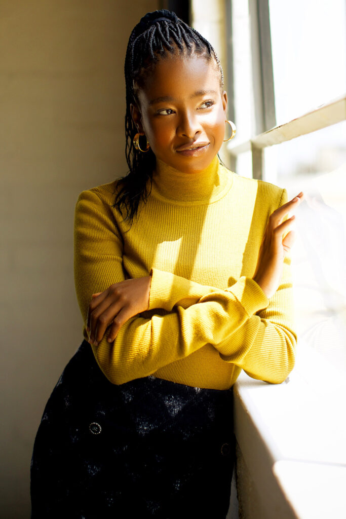 Amanda Gorman standing close to the window