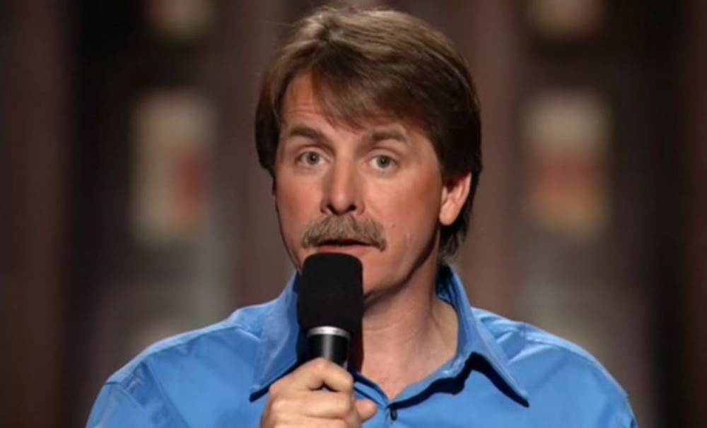 Jeff Foxworthy performing on stage holding a microphone