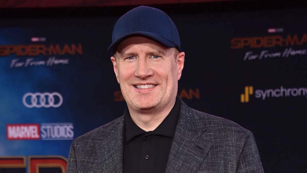 Kevin Feige smiling at the camera and wearing a blue face cap