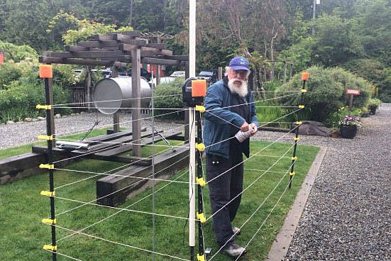 man building up an electric fence