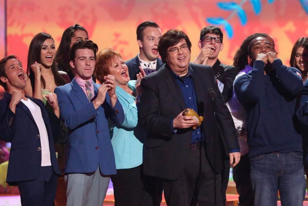 Dan Schneider on stage with his team