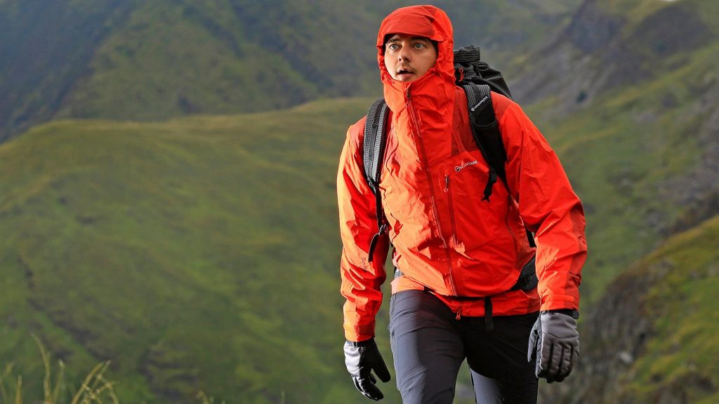 man wearing a red winter jacket with hand gloves