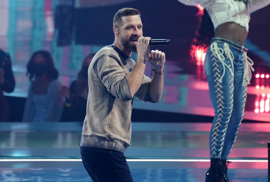 Walker Hayes performing on stage holding a microphone