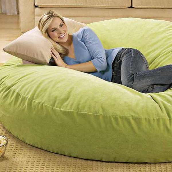 A woman sleeping on a green bean bag