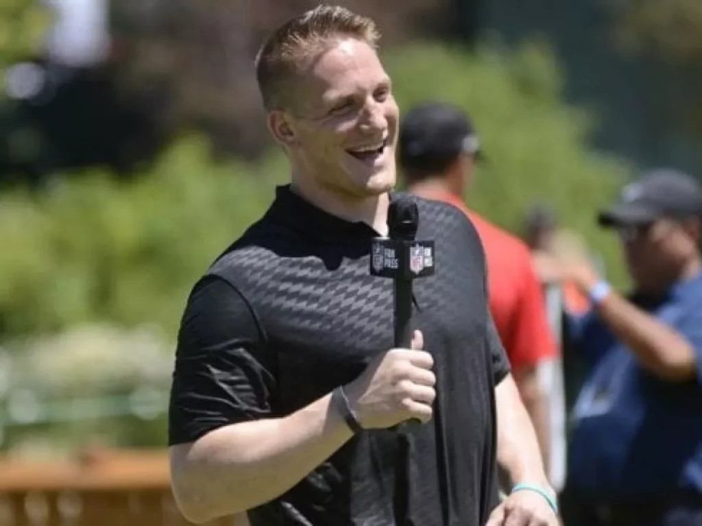A.J Hawk talking with a microphone and smiling