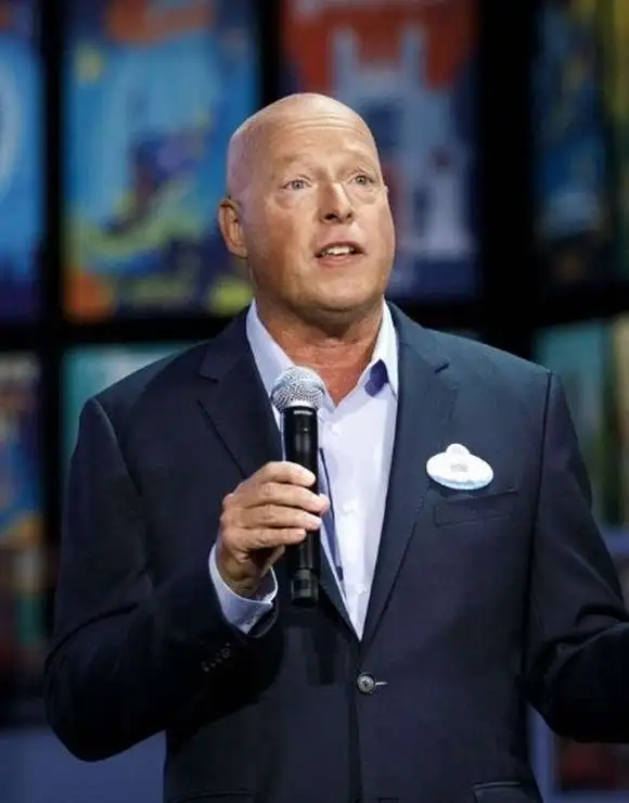 Bob Chapek holding a microphone on stage 