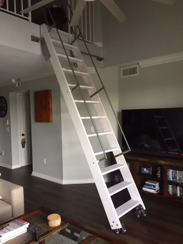 a white ladder staircase with hand rails installed in the living room