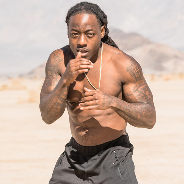 Ace Hood shirtless wearing a black short