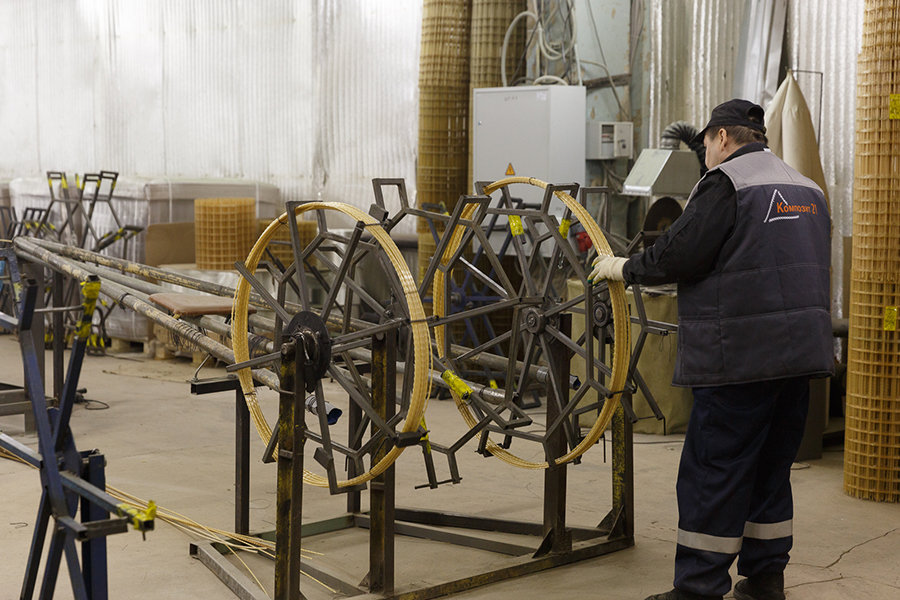 a worker inspecting the manufacturing processes of fiberglass rebar