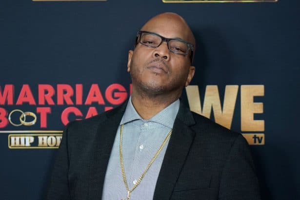 Styles P on a black suit with glasses